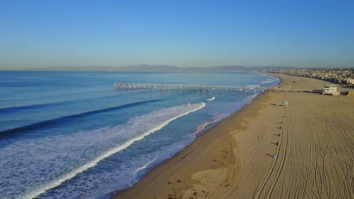 Aerial drone uav view of a pier over the beach and ocean.