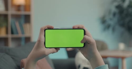 Close Up of Man Sliding on Chroma Key Screen of Smartphone