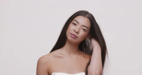 Attractive Woman Posing in Front of White Backdrop
