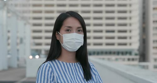 Woman wear face mask and look at camera