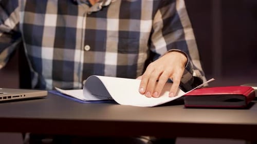 Businessman Reading Important Paperwork in Home Office