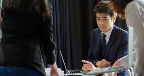 Businesspeople Collaborate on a Project in Modern Office