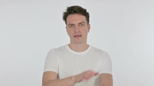 Disapproving Young Man Rejecting By Arm Gesture on White Background
