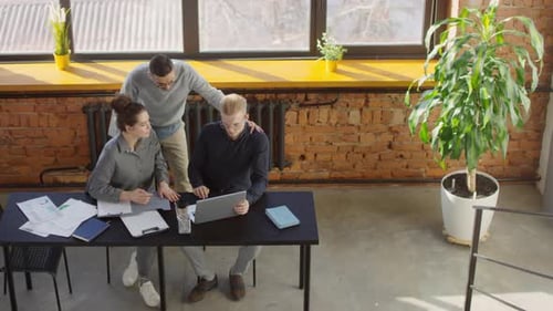 Colleagues Working In Bright Loft