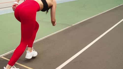 Close Up Sporty Woman Running at Athletics Track. Female Runner Preparing