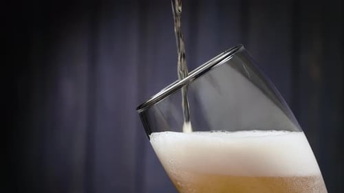 Foamy Beer Pouring into a Glass