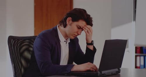 Man Working on Laptop in Office