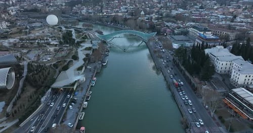 Aerial view of Tbilisi city central park and Bridge of Peace. Beautiful cityscape of old Tbilisi