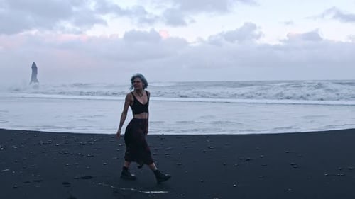 Cool Girl Walking On Black Sand Beach