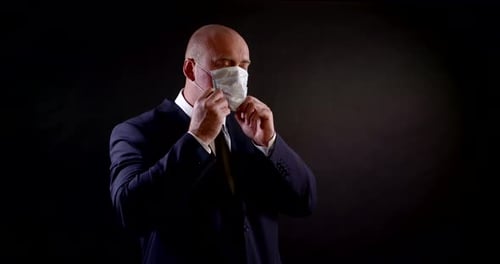 Adult Puts on Surgical Mask, Gives Thumbs Up