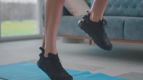 Man's Legs Stepping on Exercise Mat