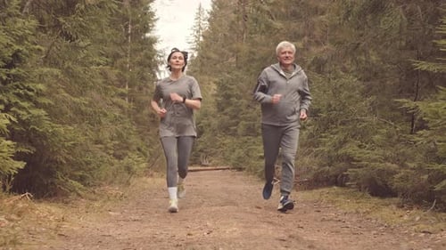 Mature Couple Jogging in Forest
