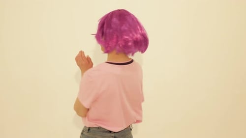 Young Woman with Pink Wig Dancing Happily