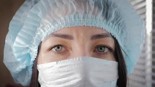 Woman Wearing Protective Surgical Cap and Mask