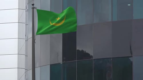 Mauritania Flag Waving In Front Of Modern Corporate Building