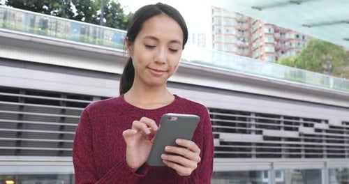 Woman Using Smartphone in Urban Environment