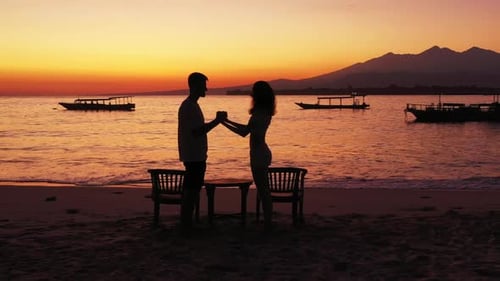 Family of two tanning on tropical coastline beach journey by blue water and clean sandy background o