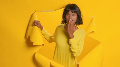 Woman Posing with Torn Yellow Paper Background
