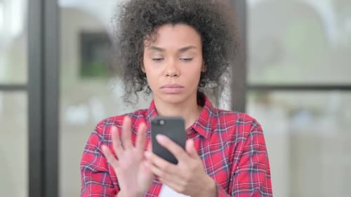 Young Woman Using Smartphone Indoors, Close Up