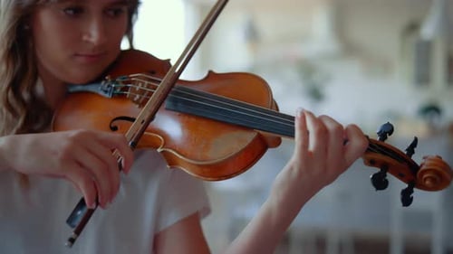 Young Woman Plays Violin Indoors, Close Up