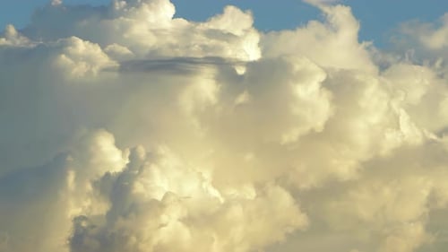 Beau fond de ciel bleu, de nuages blancs et moelleux, doucement et rapidement au coucher du soleil, au Ralenti.