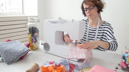 Small Business and Hobby Concept. Fashion Designer Working on Her Designs in the Bright Studio