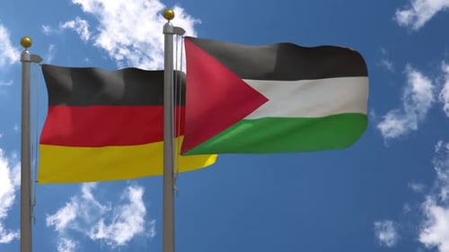 Waving Flags of Germany and Palestine on Blue Sky