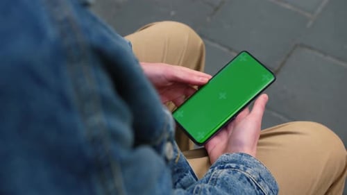 View From Shoulder of Caucasian Man Doing Swipe Up Gesture on Chroma Key of Modern Smartphone