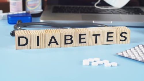 Diabetes Blocks with Pills on Doctors Desk