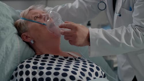 Close Up of Doctor Putting Oxygen Mask on Patient with Disease