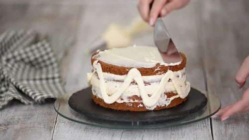Cake Being Iced with White Frosting