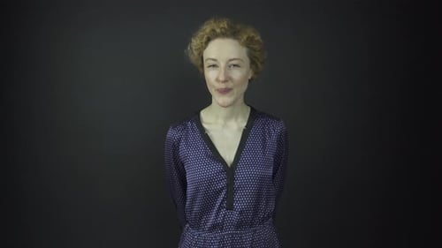 Woman with Curly Hair Smiling in Mid Shot