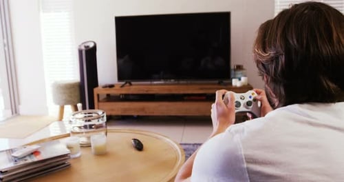 Man Plays Video Games in a Bright Living Room