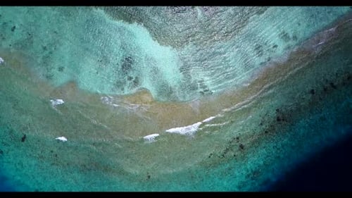Aerial drone landscape of idyllic shore beach trip by transparent ocean with white sand background o