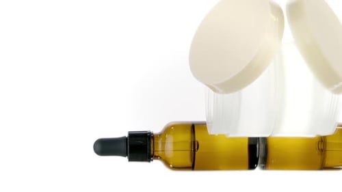 Amber Bottles and White Containers on White