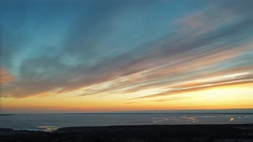 Dramatic Sunset Over Calm Waters From Above