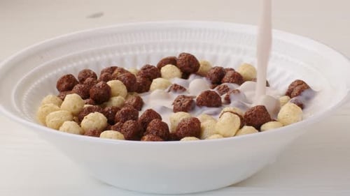 Milk Being Poured into Cereal Bowl
