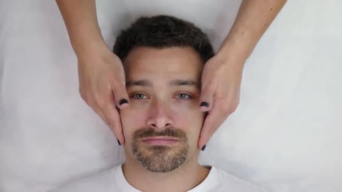 Man Receives a Relaxing Facial Massage
