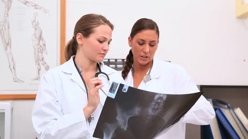 Female Doctors Examine X-ray in Medical Office