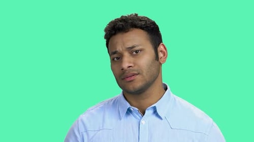 Upset Young Man on Color Background