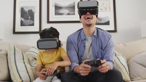 Father and Child Experiencing Virtual Reality on Couch