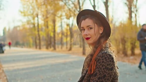 Happy Playful Woman in Coat Hat and Scarf in Autumn Park