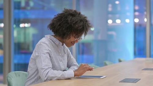 Young African Businesswoman Using Tablet in Office