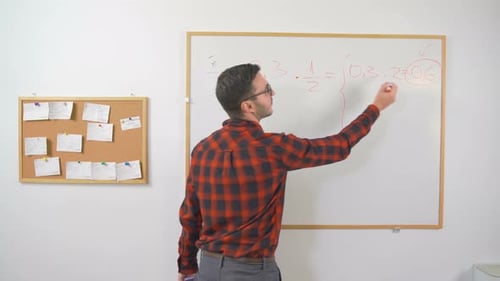 Man Writes Math Equations on Whiteboard