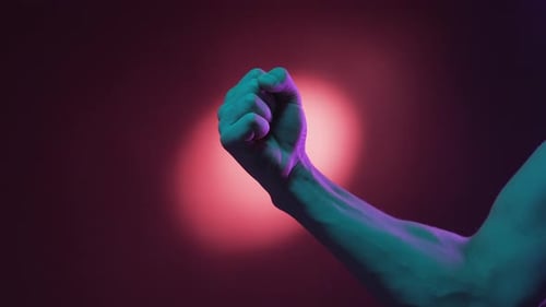 Hands Connect in Colorful Futuristic Lighting
