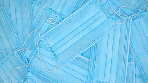 Pile of Blue Disposable Surgical Masks Close Up