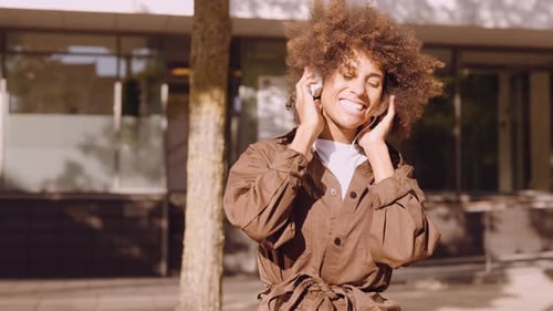 Woman Enjoying Music with Headphones Outdoors