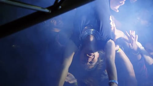 Woman Crowd Surfing at Energetic Nightlife Event