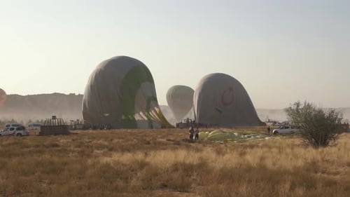 Hot Air Balloons Awaiting Flight in Field