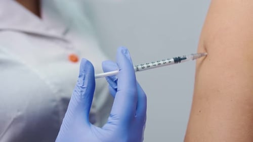 The Doctor Uses a Hypodermic Needle and Syringe To Inject Medication As Treatment